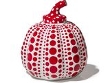 a red and white polka dot pumpkin with a red bow on top