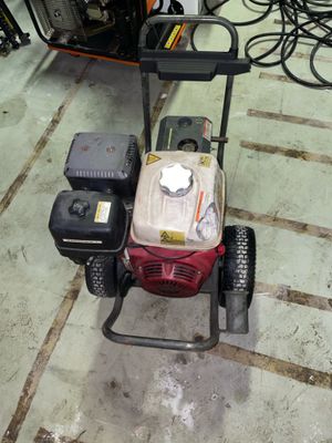 an image of a small gas powered lawn mower in a garage