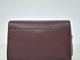 a brown leather wallet sitting on top of a white table