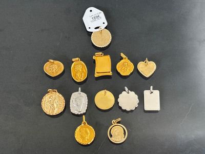 several gold and silver medals and tags on a black surface