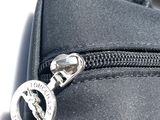 a close up of a black bag with a silver zipper
