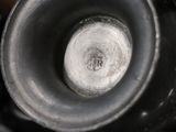 a close up view of a black vase with a silver lid