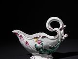 an image of a white and pink porcelain bowl on a black surface
