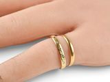 a close up of a person ' s hand with a ring on it