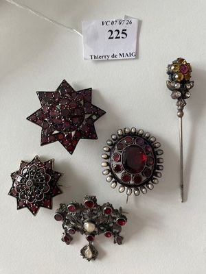 several pieces of jewelry are displayed on a white surface with a price tag