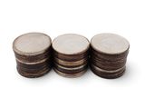 a close up of a stack of coins on a white surface