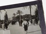 a black and white photo of a woman walking down the street
