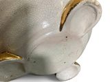 a white ceramic elephant with a gold rim on it ' s head