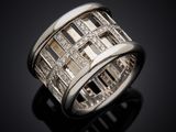 a close up of a diamond ring on a black surface