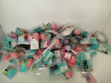 a pile of toothbrushes and toothpaste on a table