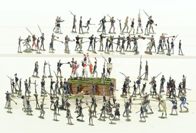 a lot of figurines that are standing in the shape of a pyramid