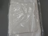 a white shirt wrapped in plastic sitting on a table