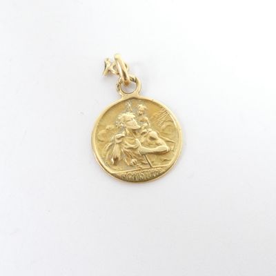 a close up of a gold coin with a woman on it