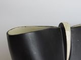 black and white vase with horn horn handles on a wooden table