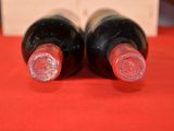 two bottles of wine that are sitting on a table