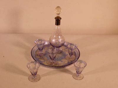a blue and white glass decanter on a tray