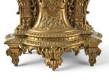 a gold clock that is sitting on top of a table