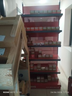 many boxes of cigarettes on the shelves in the store