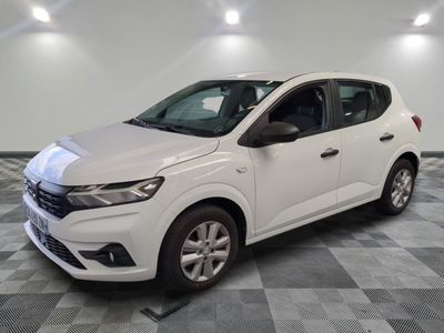 a white car parked on a checkered floor in a garage