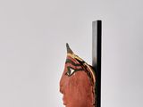a close up of a sculpture of a woman ' s head on a stand