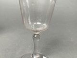 a wine glass that is sitting on top of a table