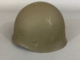 two helmets sitting on top of a white surface next to each other