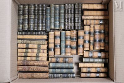 a box full of old books sitting on the floor