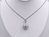 a close up of a necklace on a mannequin with a white background