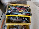 many tools in a yellow box on the floor