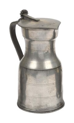 an old silver pitcher with a handle on a white background