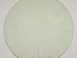 an image of a glass plate on a stand on a wooden table