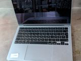 a laptop computer sitting on a table in a room
