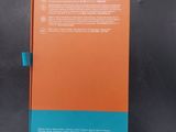 an orange and blue notebook sitting on top of a black table