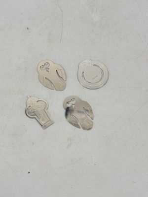 four different keys on a white surface with a hole in the middle of them