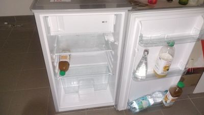 a small refrigerator with a lot of food inside of it