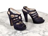 Les chaussures sont posées sur une table en marbre dont le plateau est également en marbre.