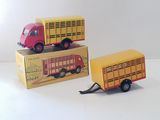 two toy trucks sitting next to each other on a white surface