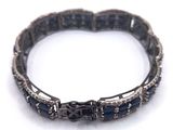 an image of a close up of a bracelet on a white surface