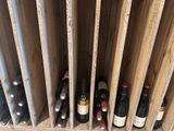 bottles of wine are lined up in a wine rack in a wine cellar