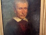 portrait of an old man in a red shirt and black coat