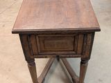 an old wooden table with a drawer on top of it