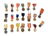 many medals and medals on display on a white surface
