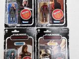 four star wars action figures are shown on a white surface