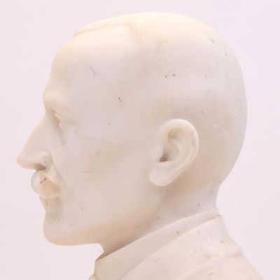 un gros plan sur une statue blanche représentant un homme chauve