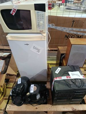 a microwave and other appliances on a pallet in a store