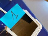 a cell phone with a sticker on it sitting on a book