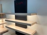 a flat screen tv on a shelf in a living room