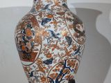 a vase that is sitting on a stand on a table