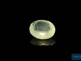 a yellow quartz stone on a black surface