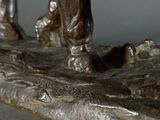 a bronze statue of a man riding a horse on a rock